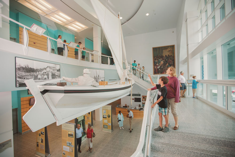 mother and son admiring hanging skiff boat at Museum of the Albemarle