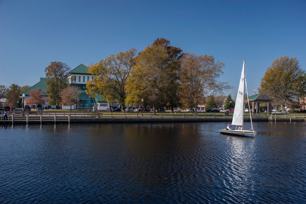 sail boat on pasquotank river with museum of the albemarle in the background