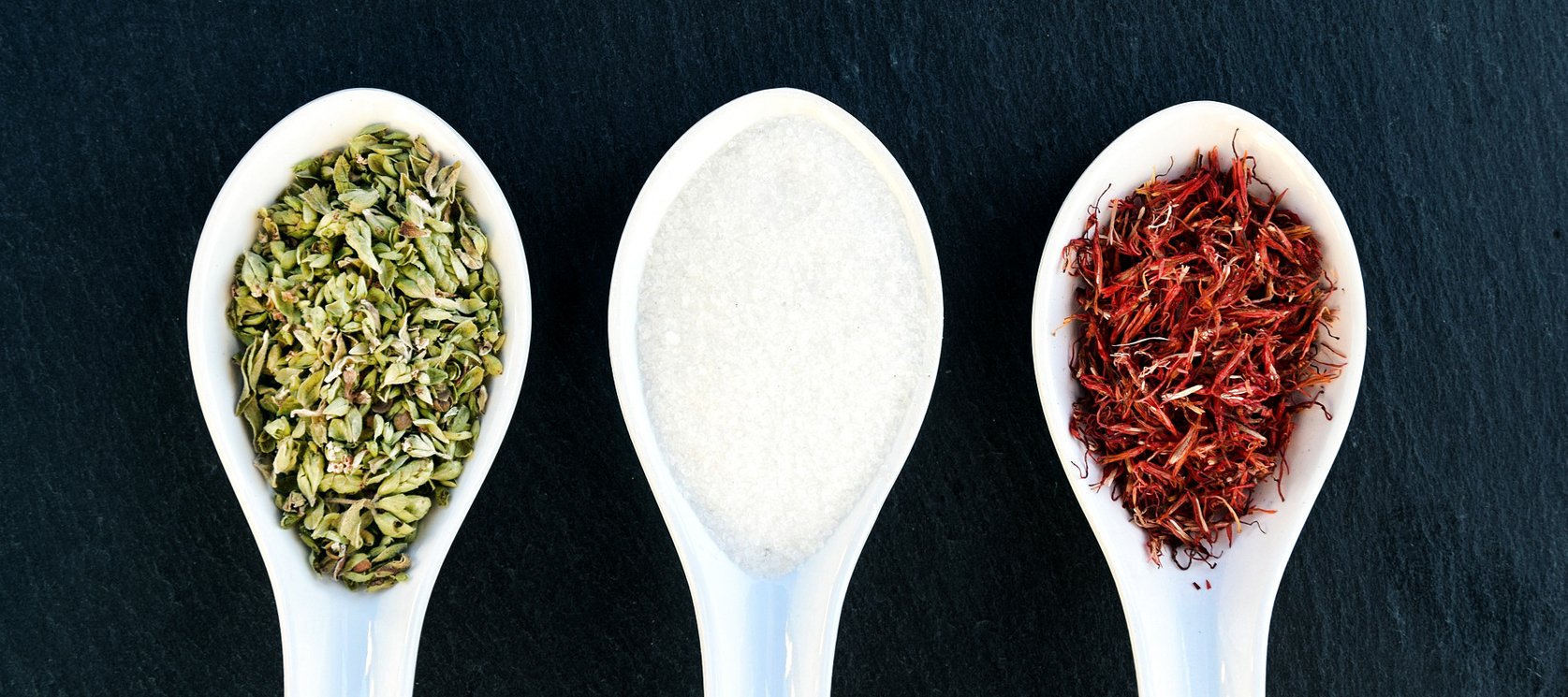 three spoons with different herbs and spices