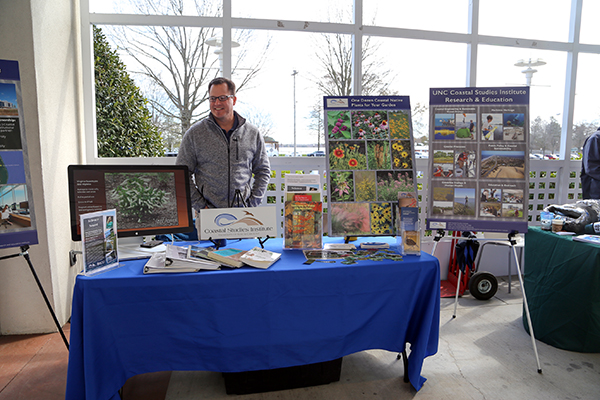 Green Saves Green presentation table with volunteer