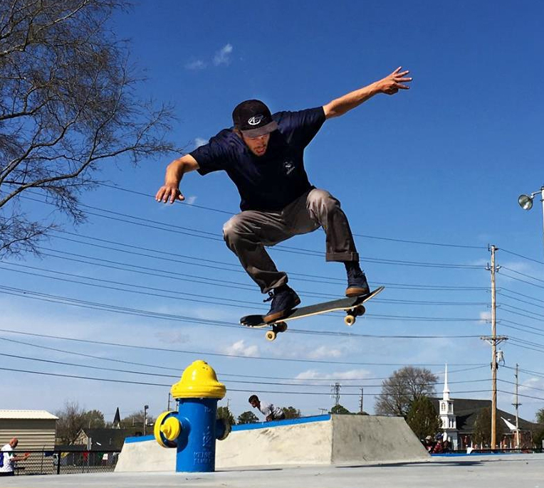 teen doing trick on skateboard at Enfield Skateboard Park