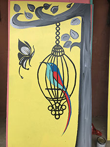 painting of bird in cage and butterfly