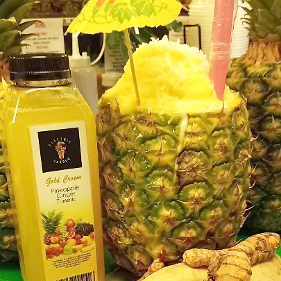 Electric garden smoothie in a pineapple paradise cup with umbrella