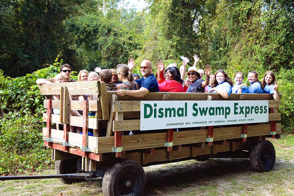 group taking tour of dismal swamp state park in back of truck