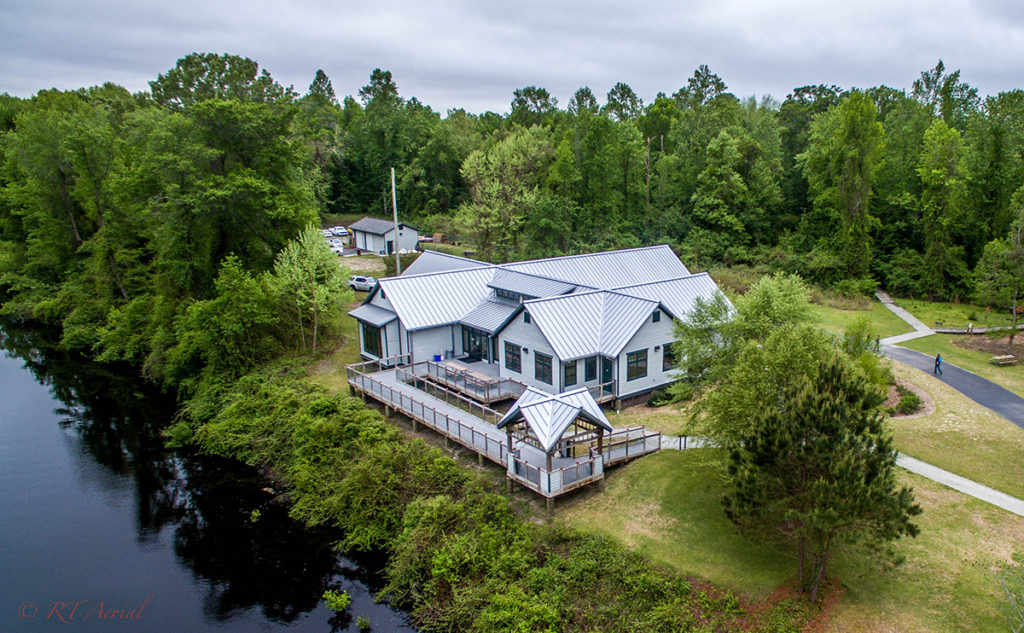 aerial photo of dismal swamp state park visitors center with trees and canal